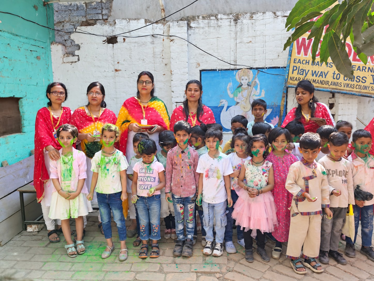 Children and teachers celebrating Holi together
