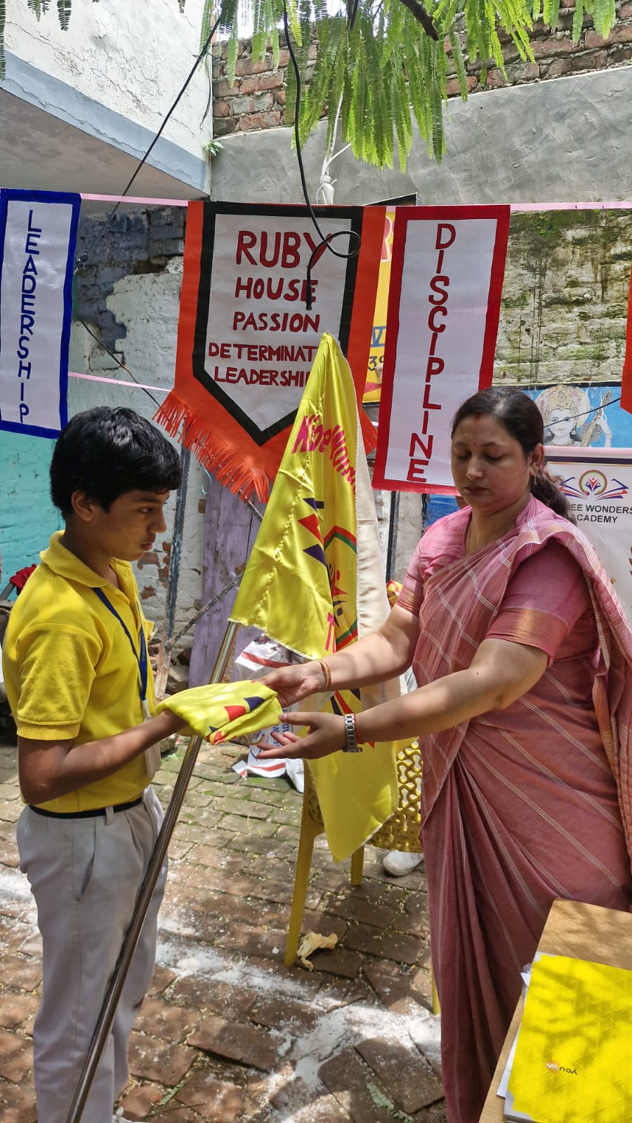 A student receiving a yellow house flag