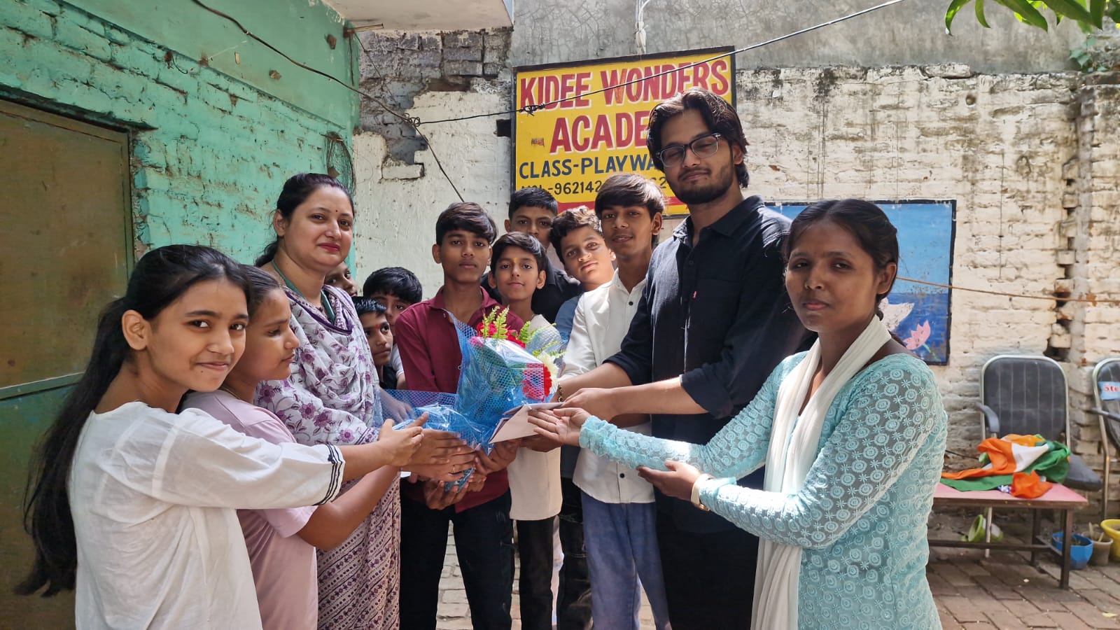 Students presenting flowers at school