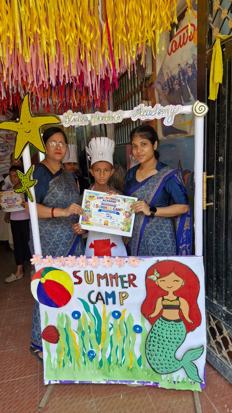 A student receiving a summer camp certificate