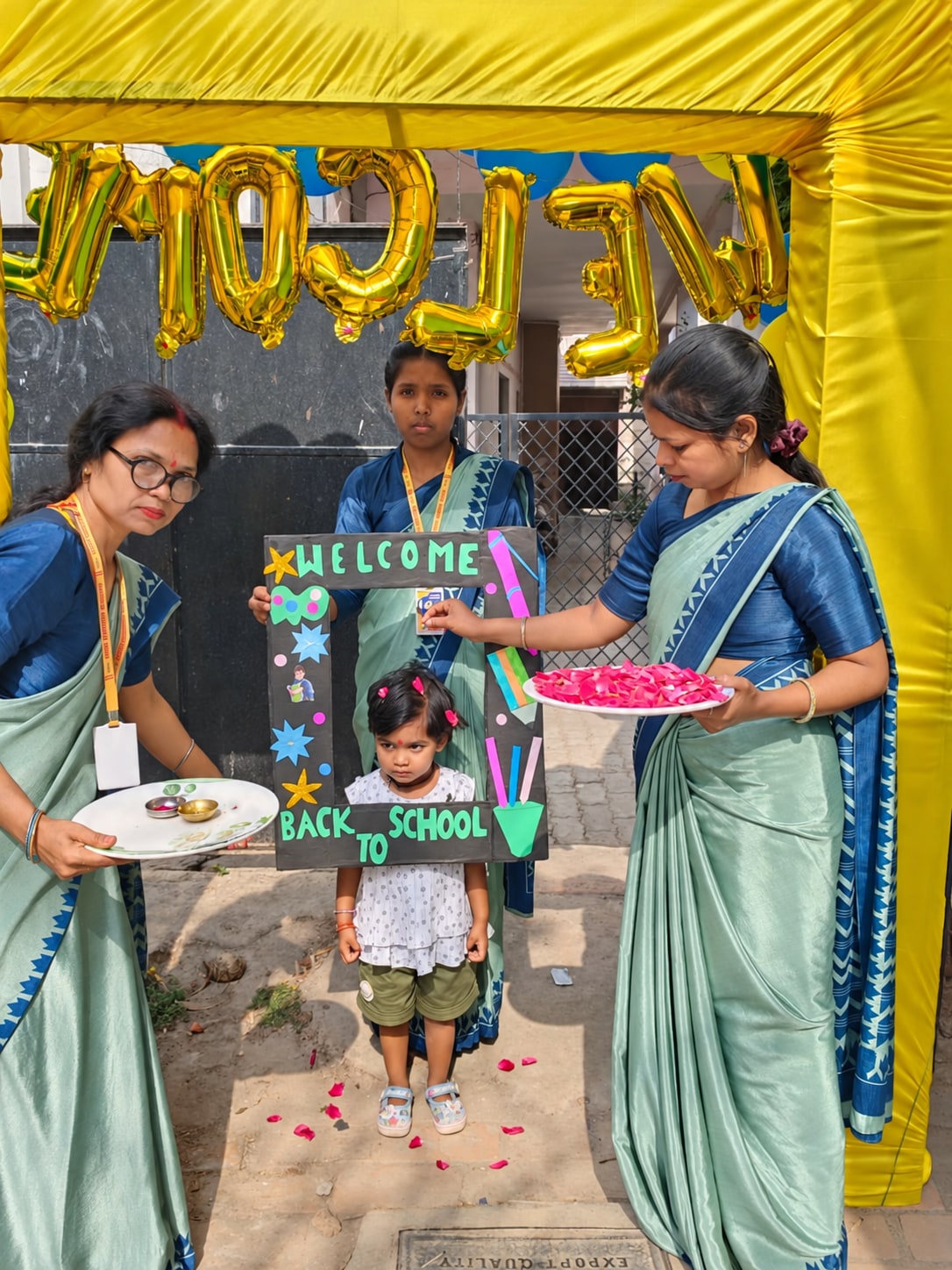 Teachers welcoming a young student